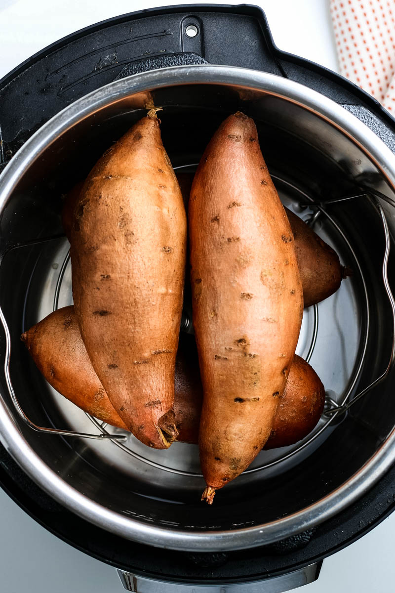 cooking whole sweet potatoes in the Instant Pot on a steaming trivet
