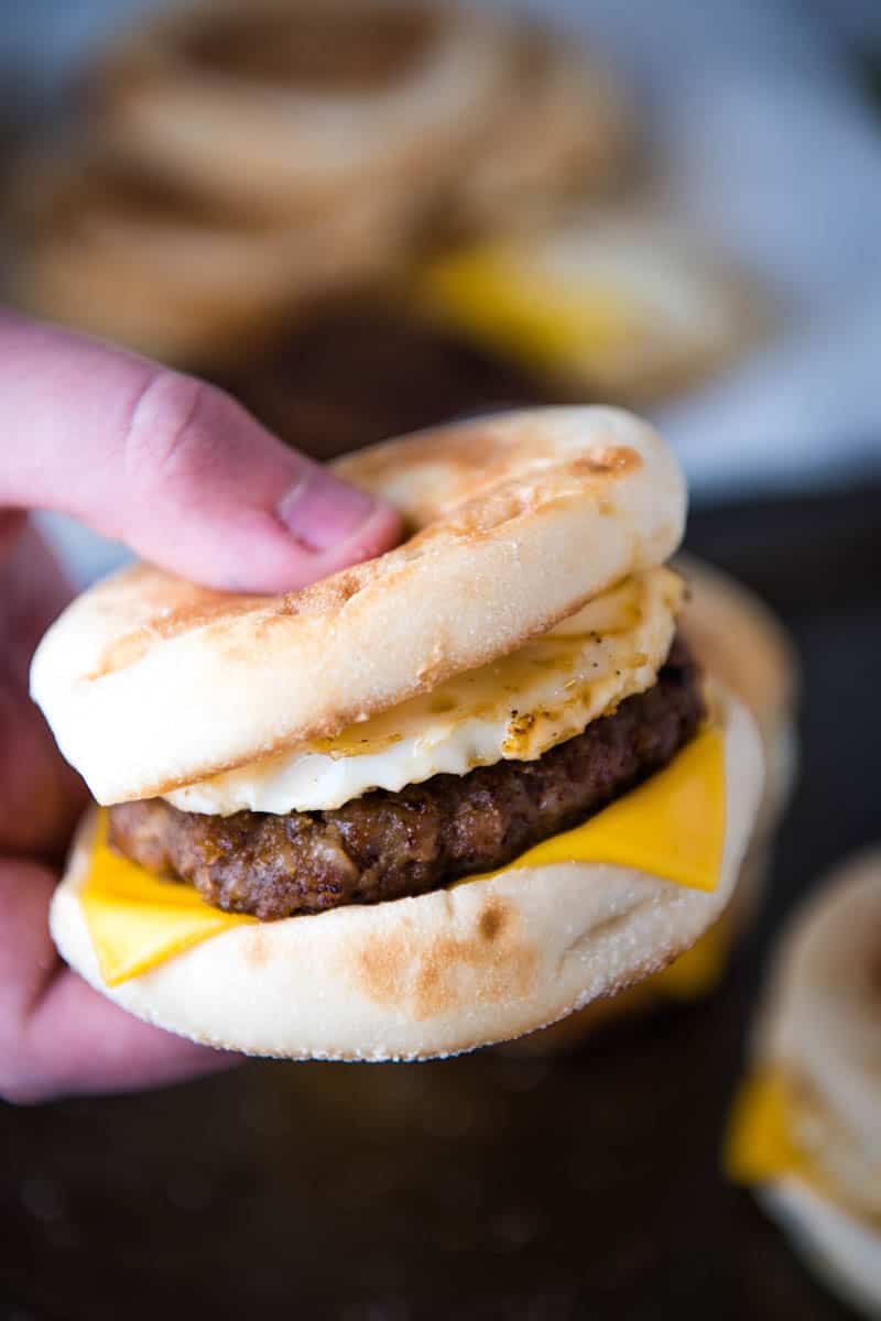 copycat version of McDonald's Sausage McMuffin in hand