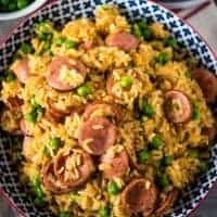 bowl of sausage and rice with peas