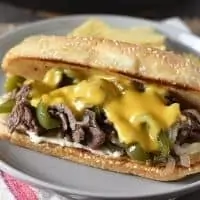 philly cheesesteak sandwich on gray plate