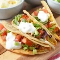 ground beef tacos on wooden cutting board
