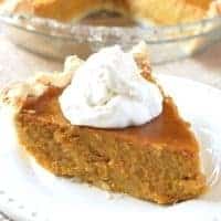 slice of pumpkin pie topped with whipped cream