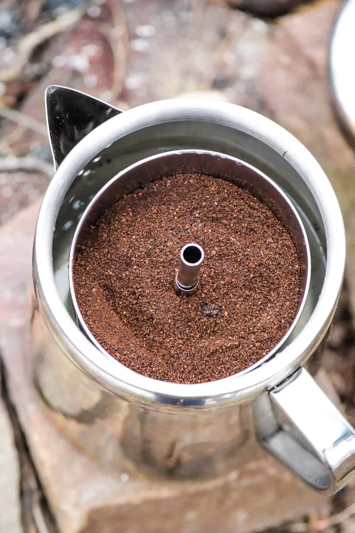 coffee grounds in basket of percolator pot