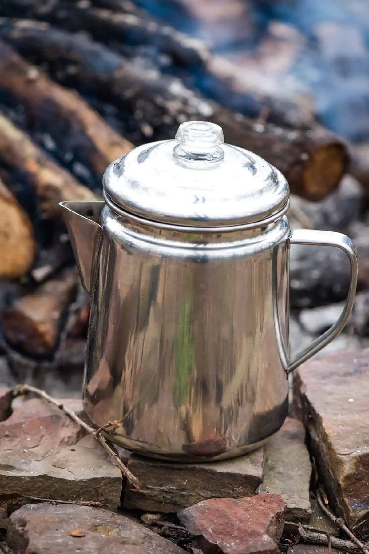 percolating camp coffee in stainless steel percolator away from direct flame