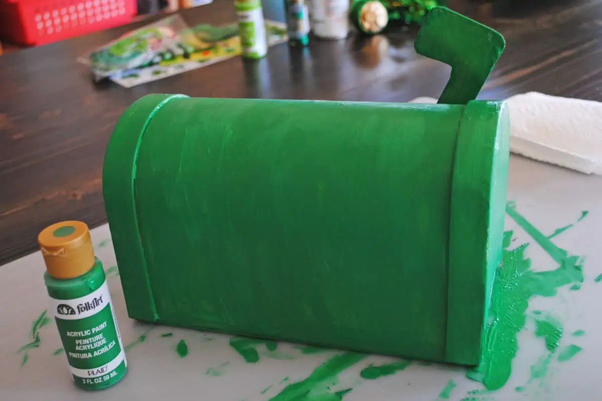 painting paper mache mailbox green for St. Patrick's Day craft