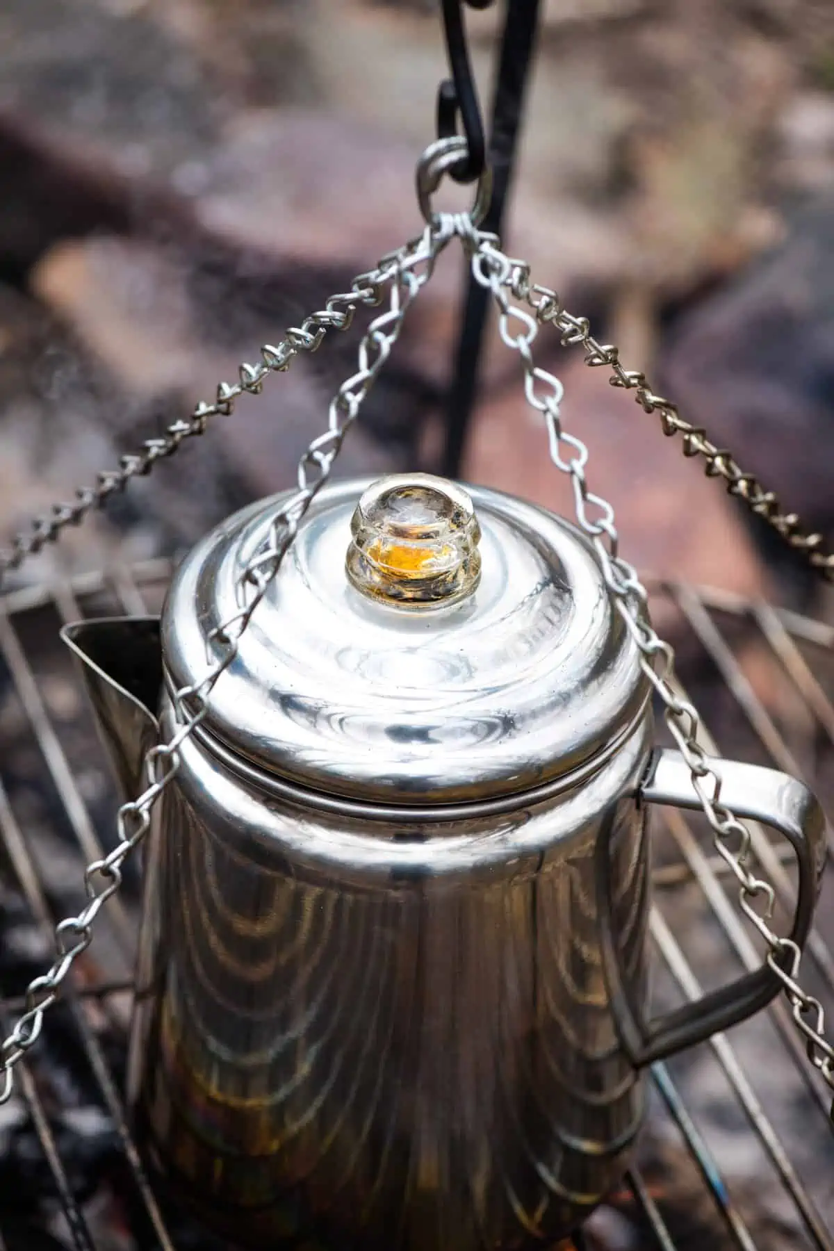 coffee percolating in the glass knob of a stainless steel camping percolator