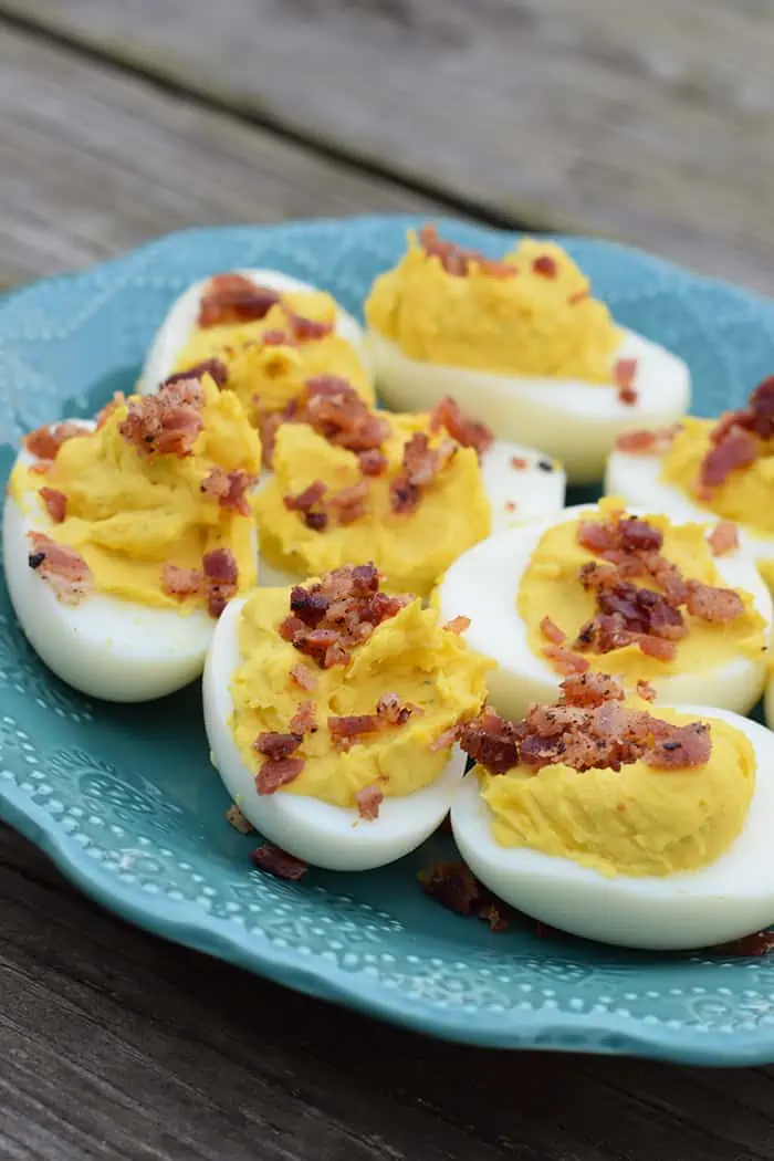 ranch deviled eggs with bacon crumbles on blue plate