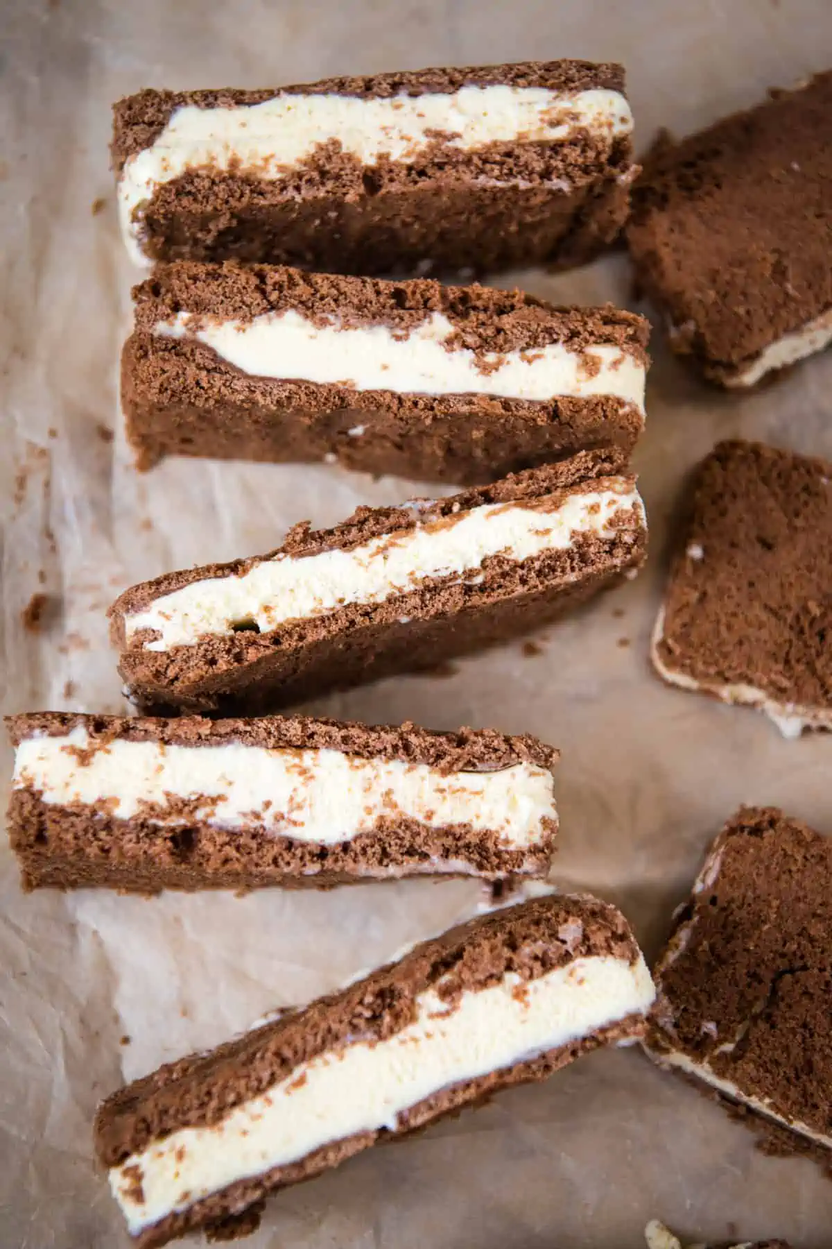 homemade ice cream sandwiches lined up on their sides on parchment paper