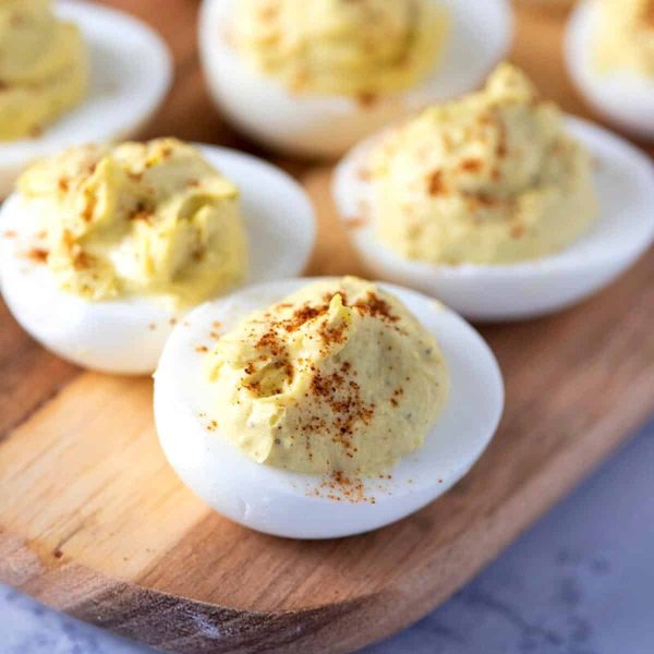 deviled eggs on wooden cutting board