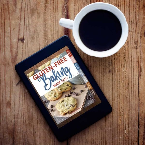 Gluten-Free Baking Made Easy cookbook on tablet with cup of coffee
