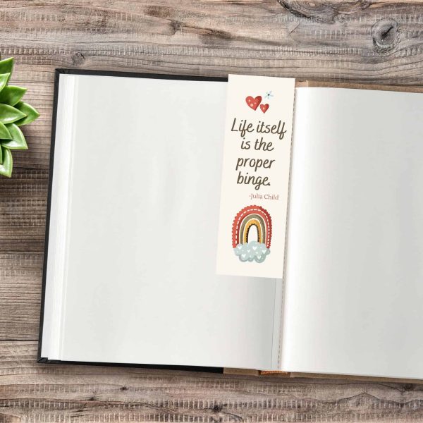 Julia Child bookmark in blank book on wooden countertop