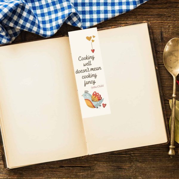 Julia Child bookmark in blank book with blue checked tablecloth