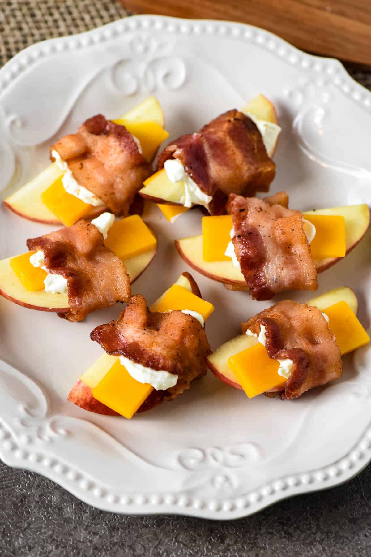 apple cheese bacon appetizer on white plate