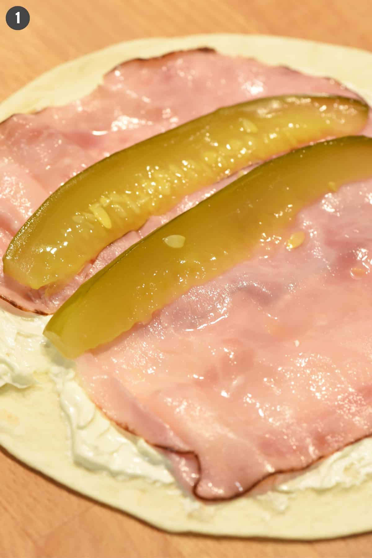 how to make dill pickle rollups using flour tortilla, cream cheese, ham, and dill pickle spears