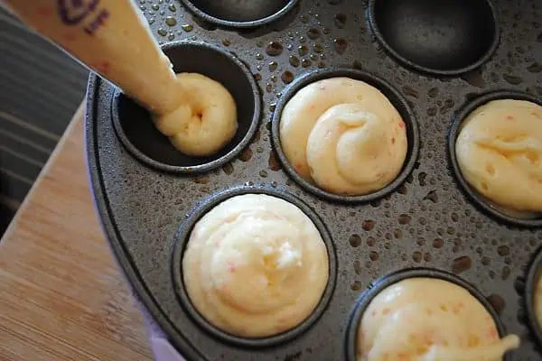 piping cherry chip cake pop batter into Babycakes cake pop maker