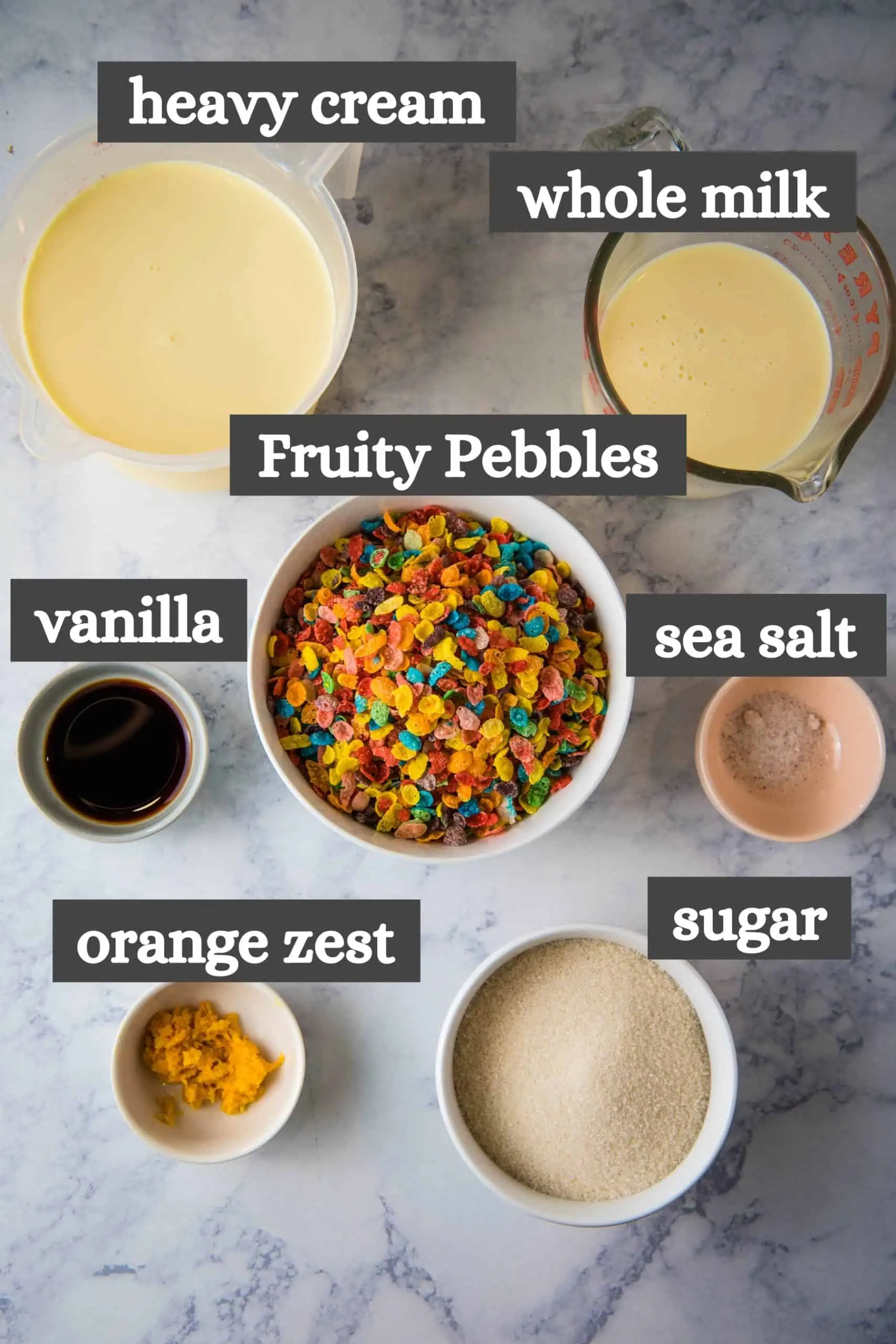 Fruity Pebbles ice cream recipe ingredients on white marble countertop