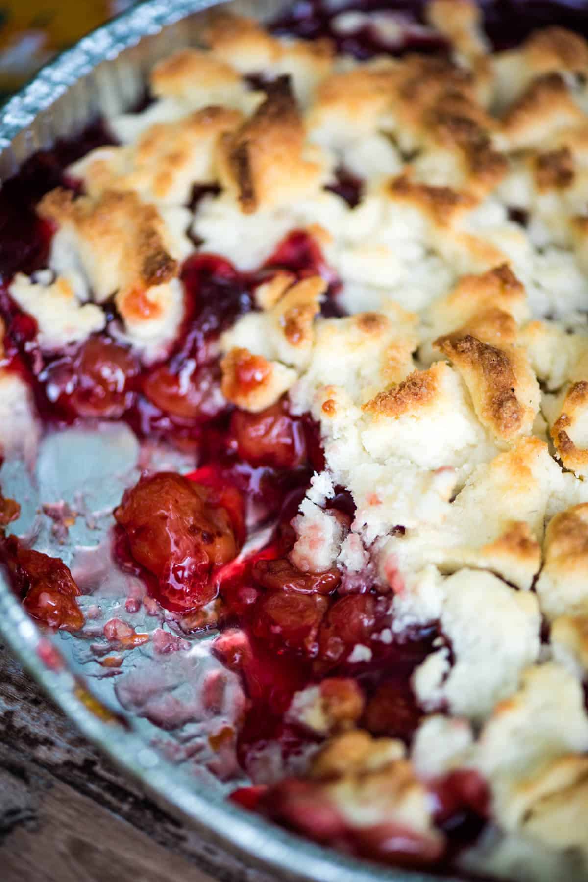 freshly baked Dutch oven cherry cobbler in an aluminum pie plate and ready to serve