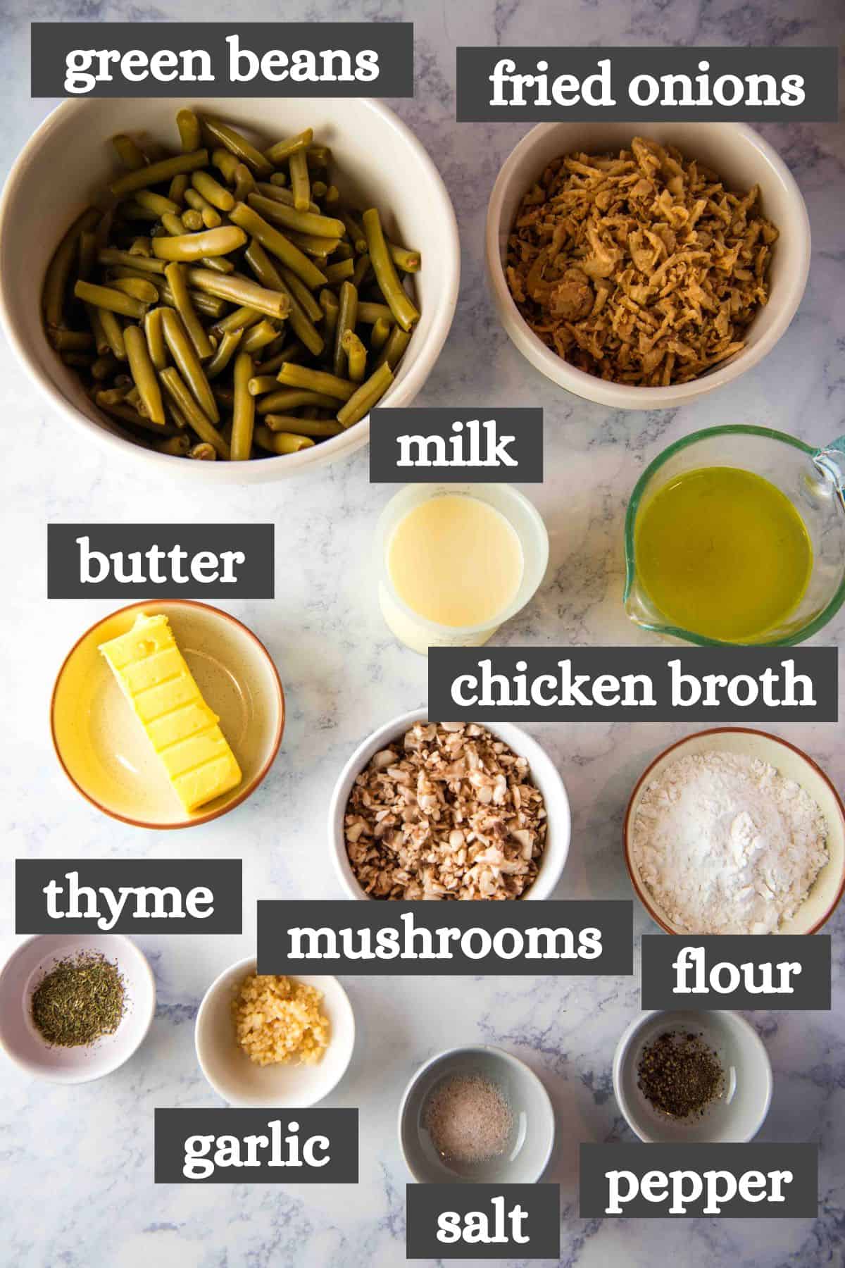 green bean casserole ingredients lined out on a white marbled countertop