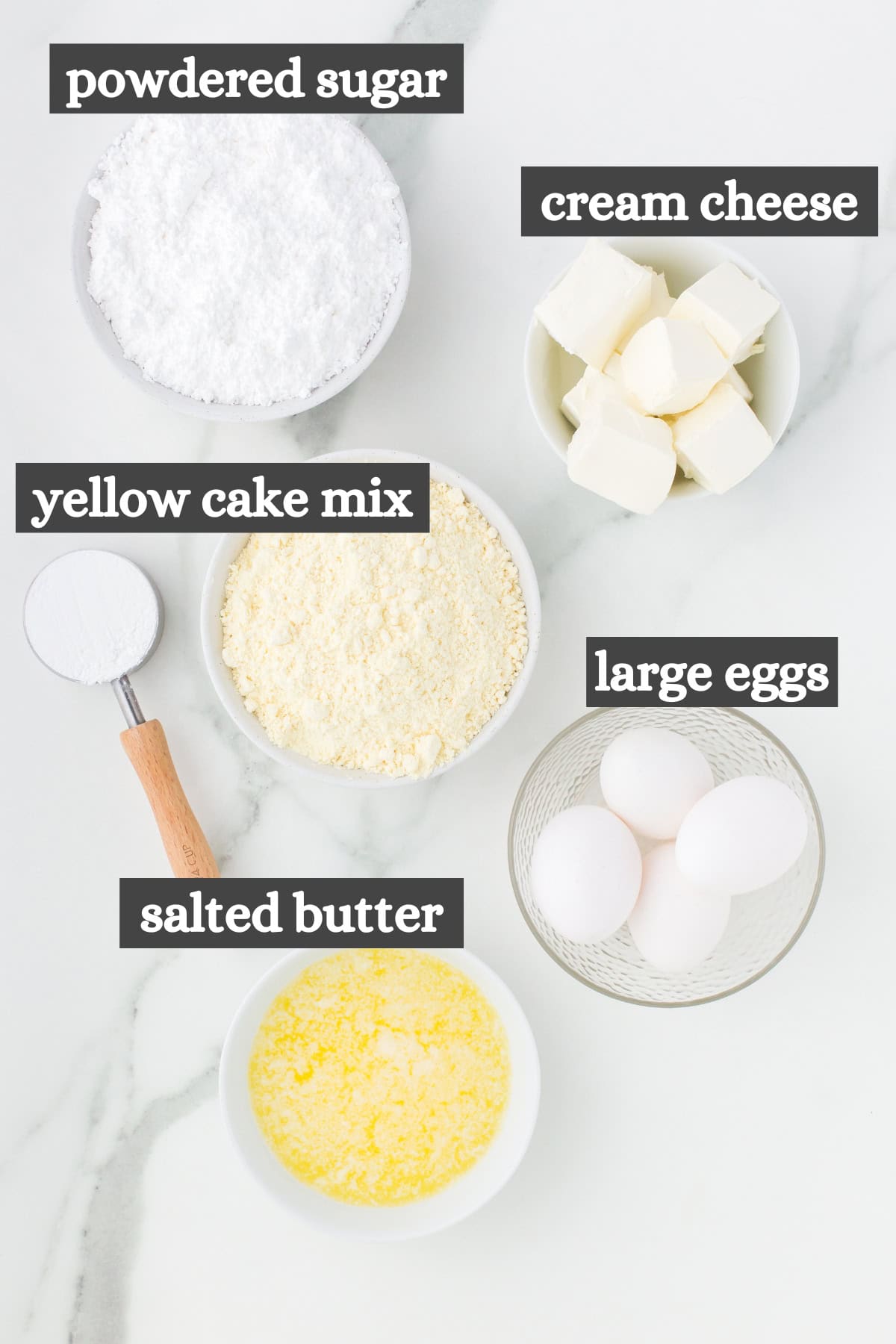 gooey butter cake ingredients in bowls on white marble countertop