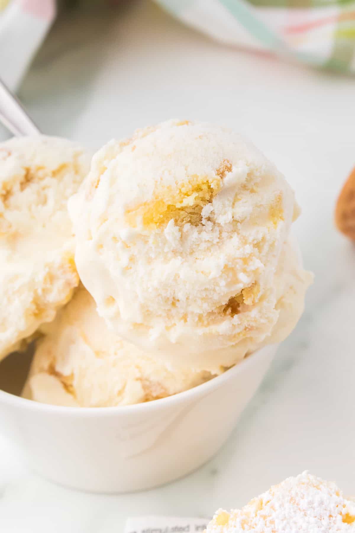 scoops of gooey butter ice cream in white bowl