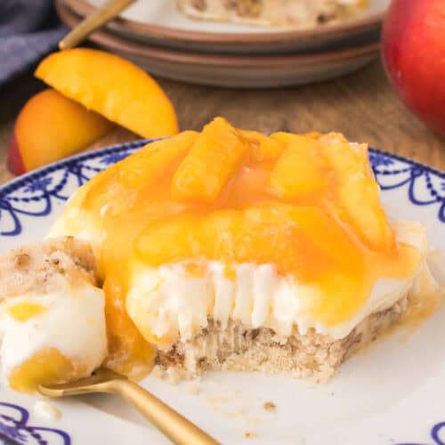 slice of peach delight on white plate with fork
