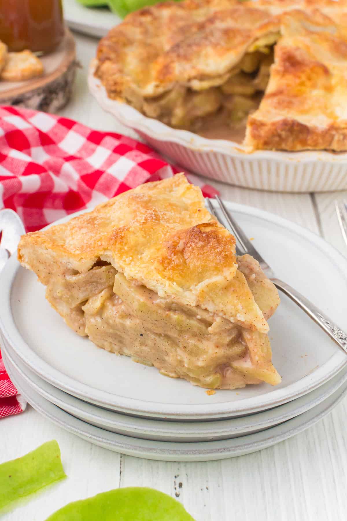 slice of homemade apple pie on gray plate