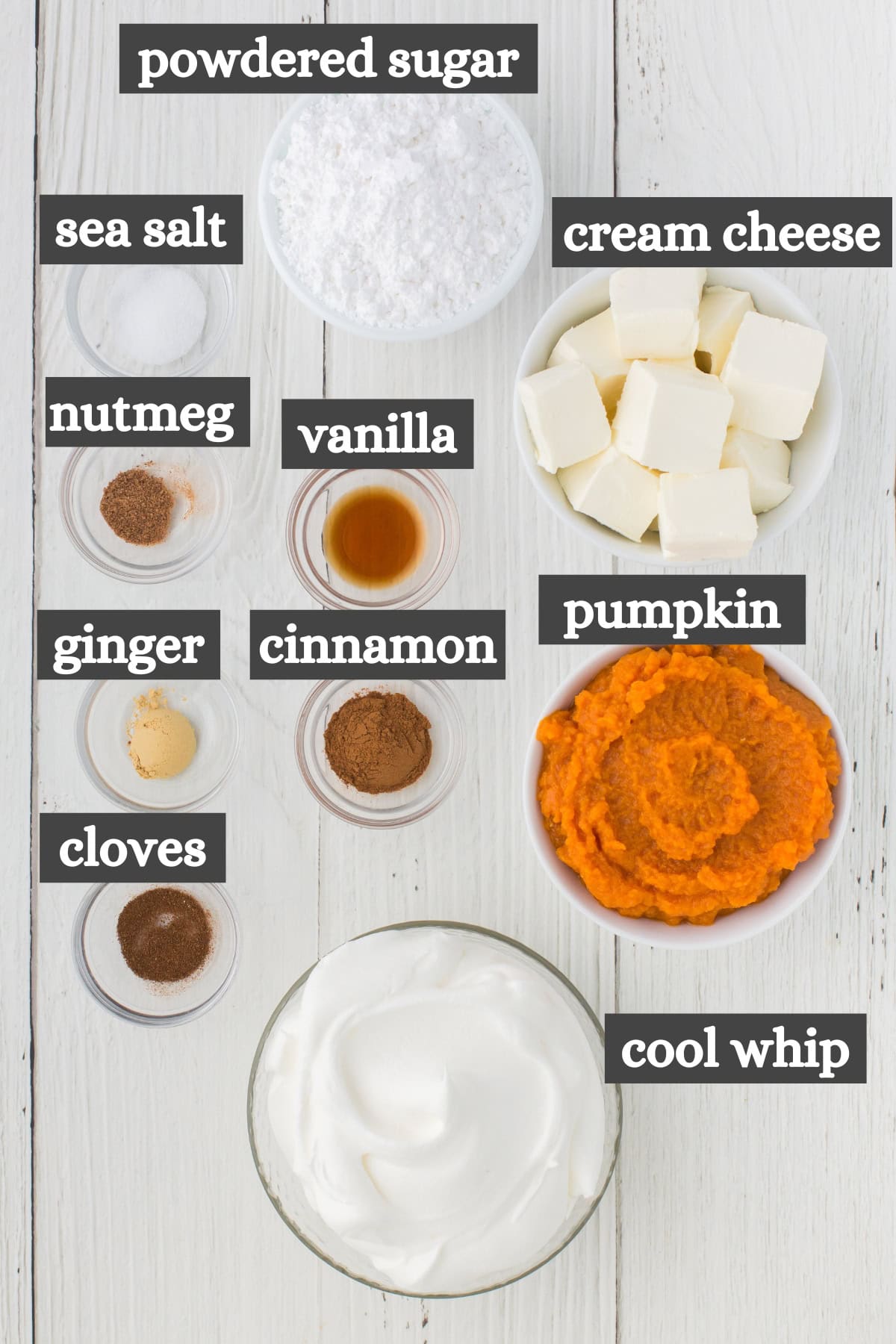 pumpkin dip ingredients in bowls on white wood countertop