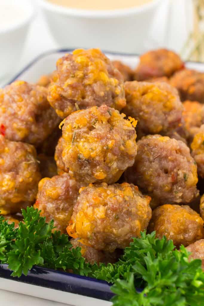 Bisquick sausage cheese balls piled up in a large glass container