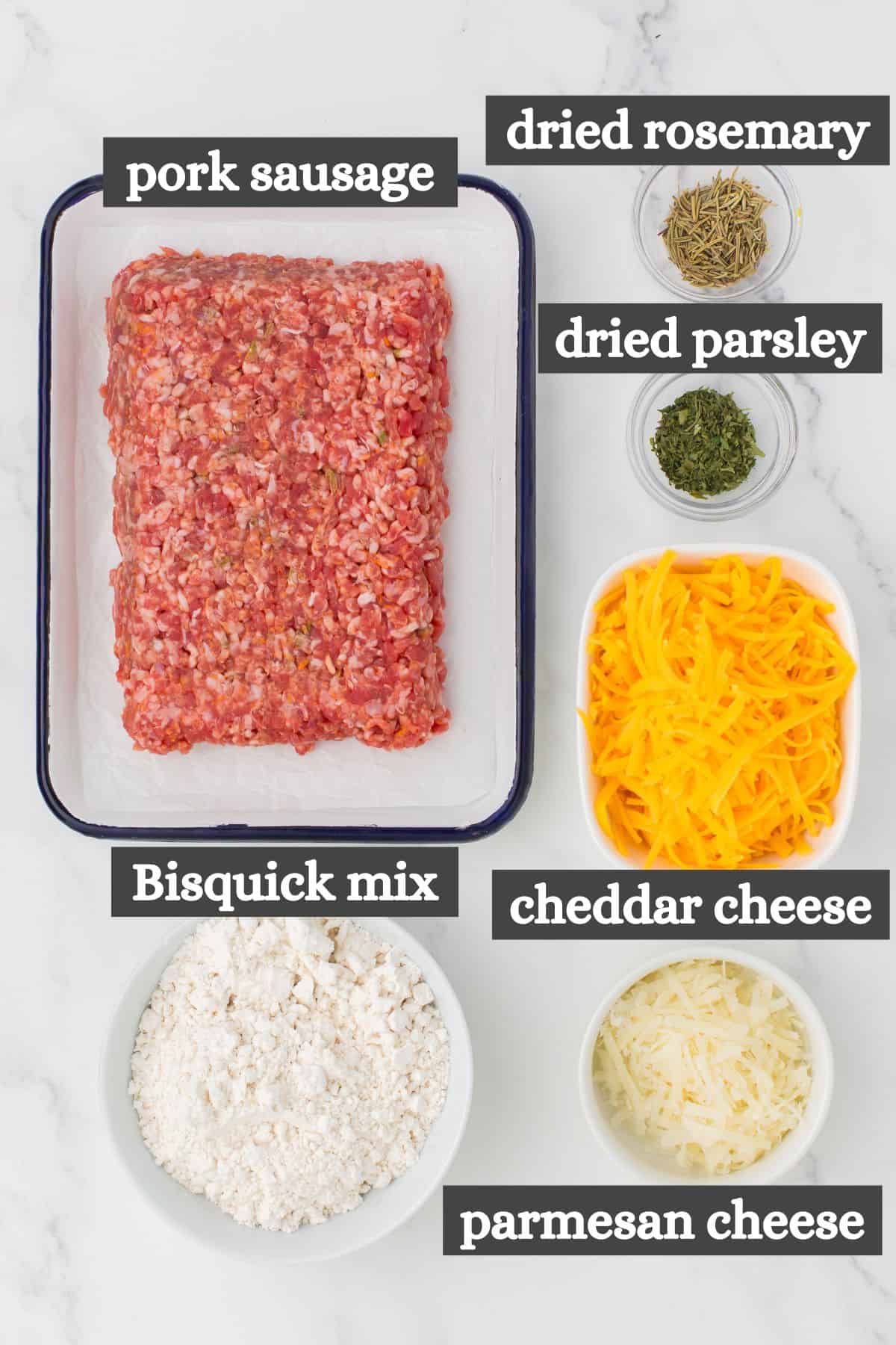 sausage and cheese balls ingredients lined out on a marbled white countertop