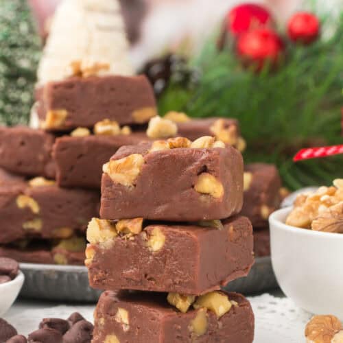 stack of marshmallow creme fantasy fudge with chocolate chips and walnuts on a white countertop