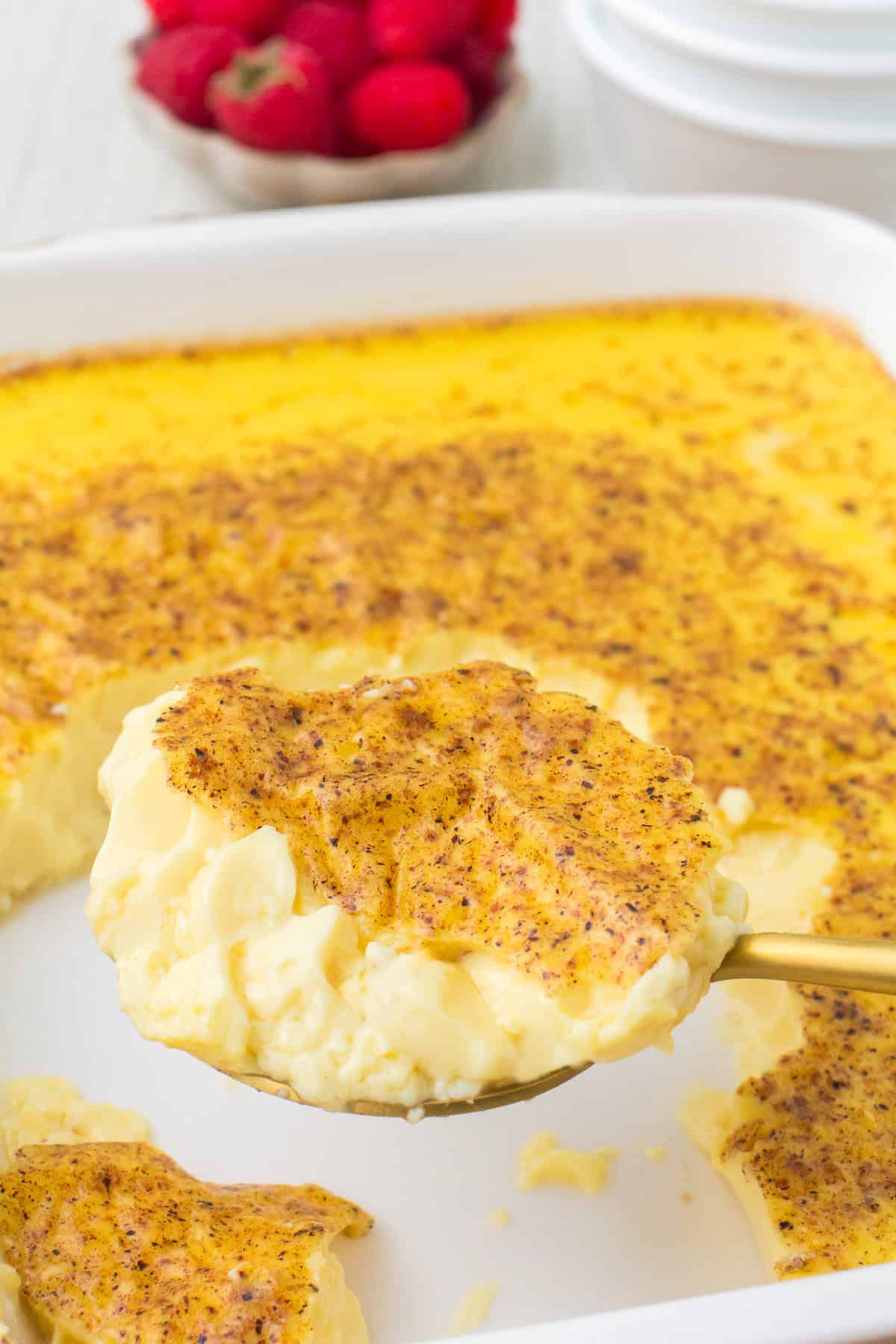 closeup photo of a spoonful of old fashioned baked custard with nutmeg on top