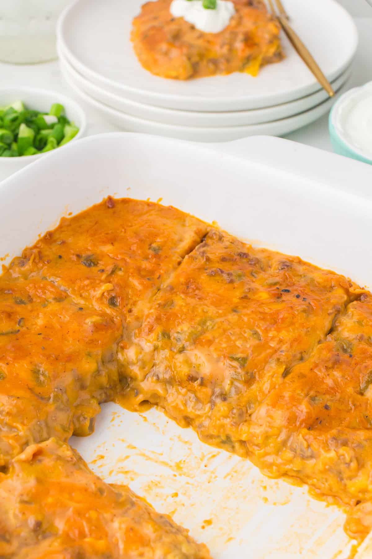 overhead shot of beef enchilada bake in a large white casserole dish