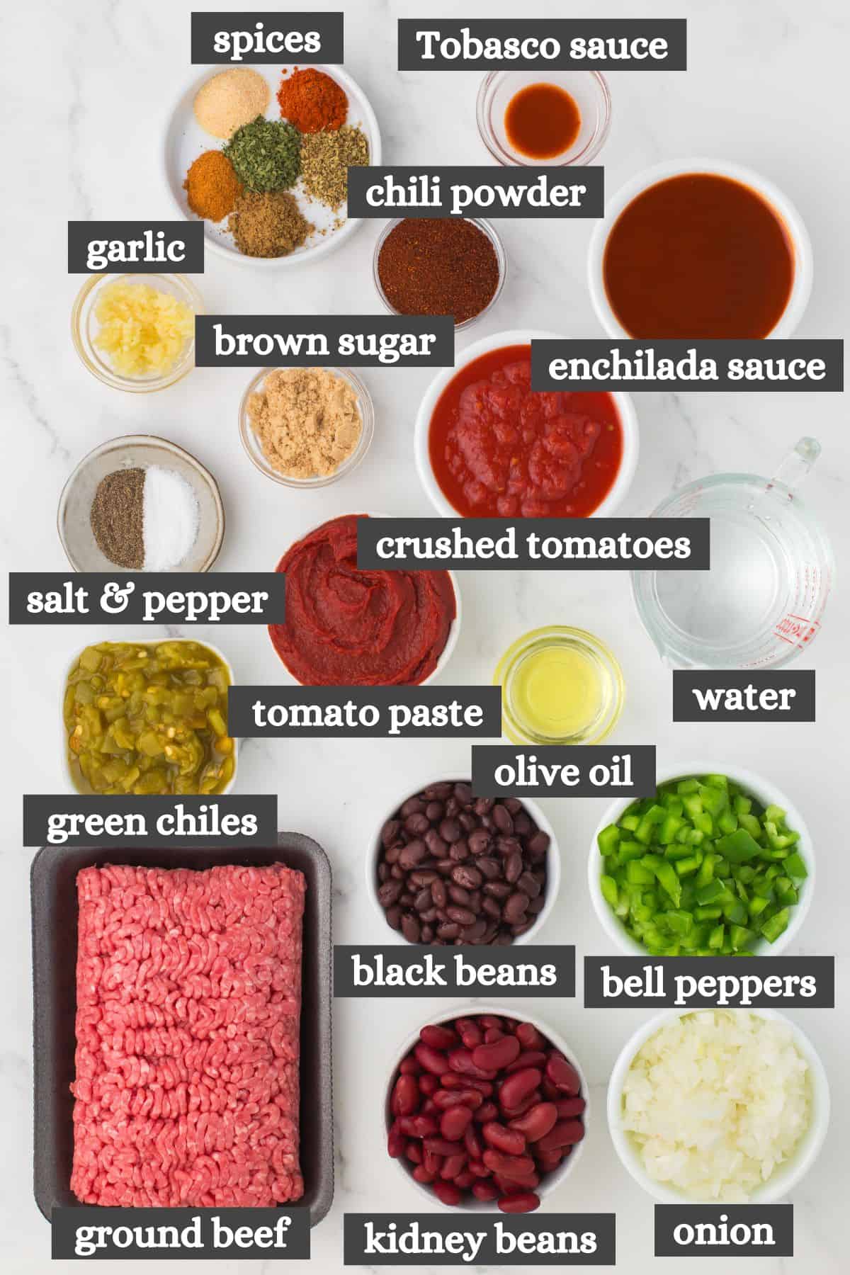 chili con carne ingredients lined out on a marbled white countertop