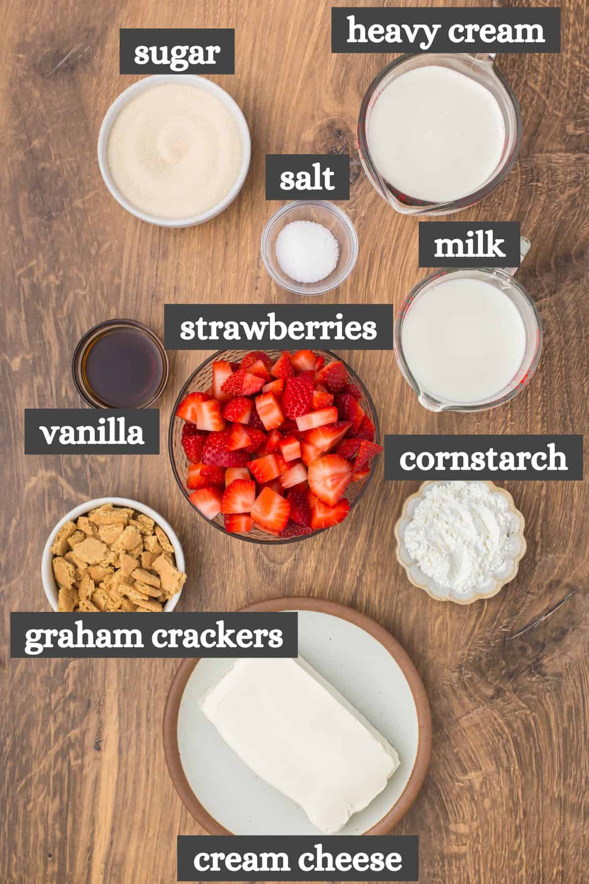strawberry cheesecake ice cream ingredients lined out on a wooden countertop