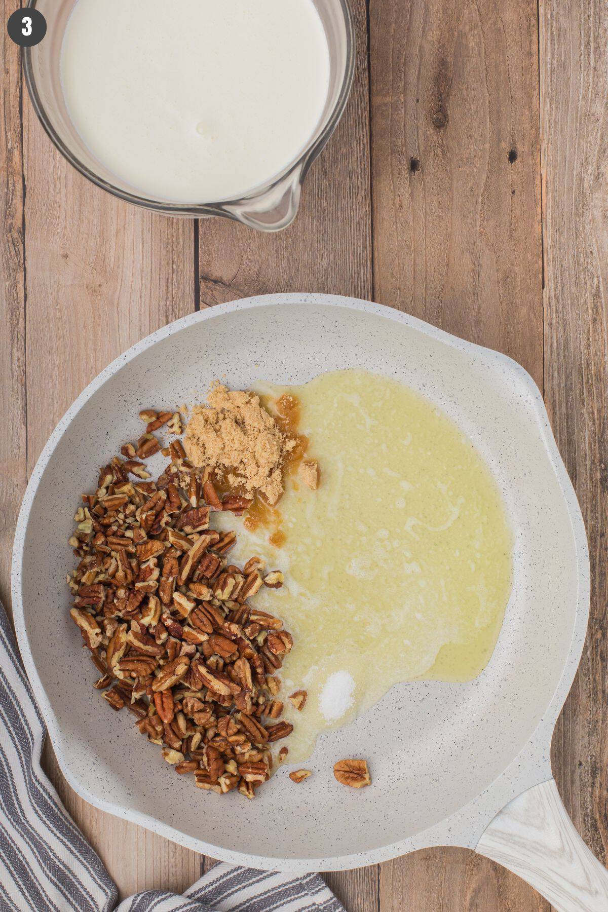overhead shot showing a pan full of melted butter and pecans for authentic southern butter pecan ice cream