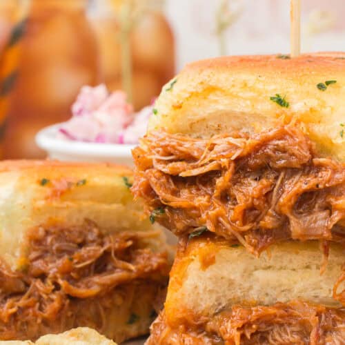 bbq chicken sliders on wood cutting board with iced tea in the background
