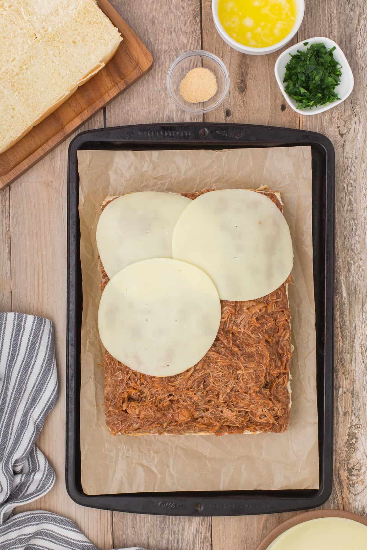 add slices of provolone cheese to top of bbq chicken sliders with chicken thighs