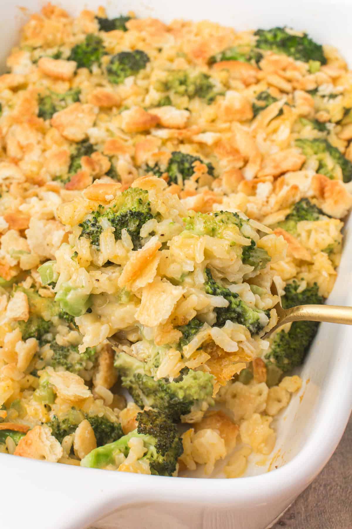 heaping spoonful of cheesy broccoli rice casserole with a buttery Ritz cracker topping