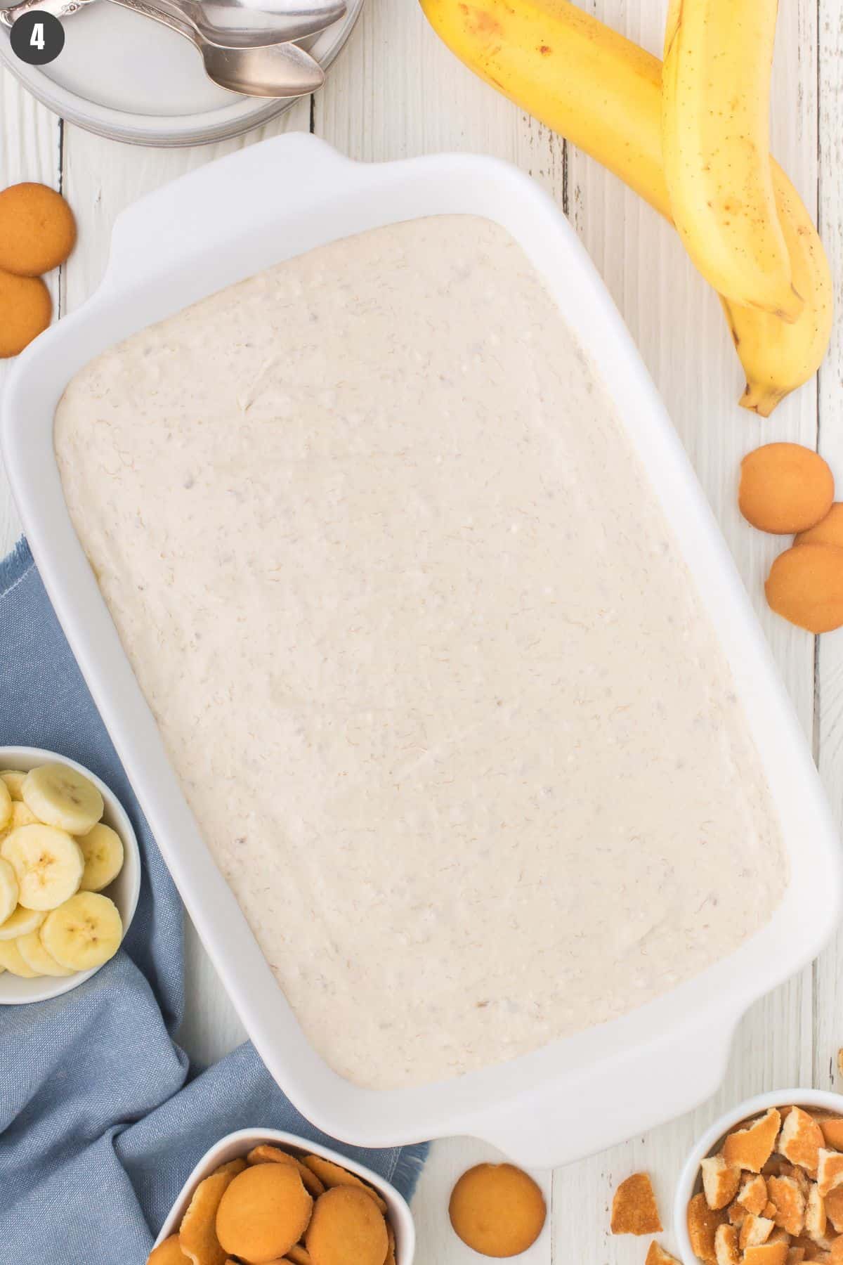 overhead shot showing no bake banana pudding without the topping in a white 9x13 casserole dish