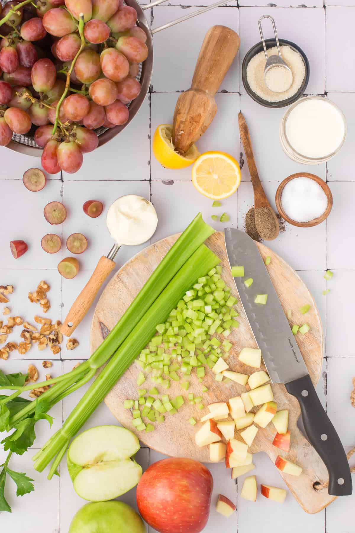 classic Waldorf salad recipe ingredients lined out on a wooden cutting board