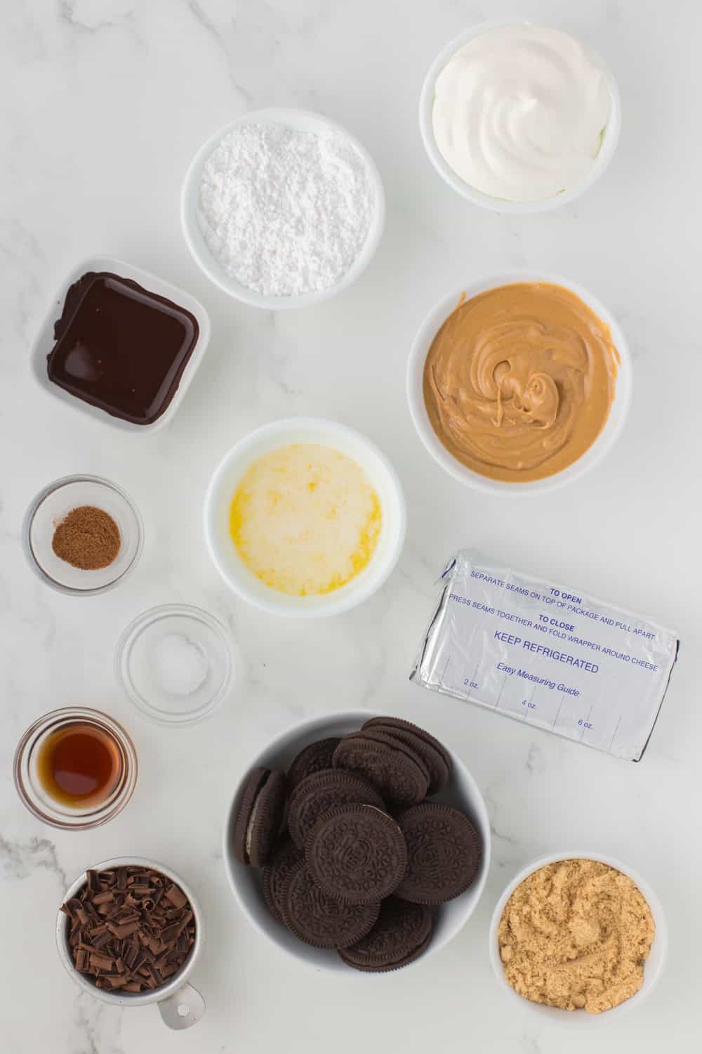 ingredients for no bake peanut butter pie recipe lined out on a white countertop